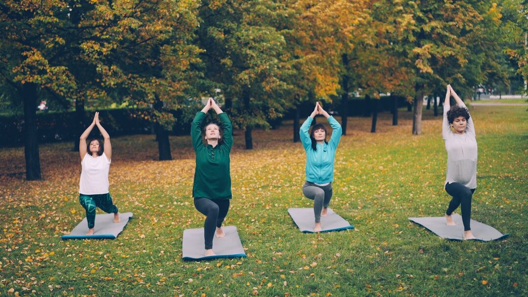 Group of seniors doing gentle stretching exercise outdoors