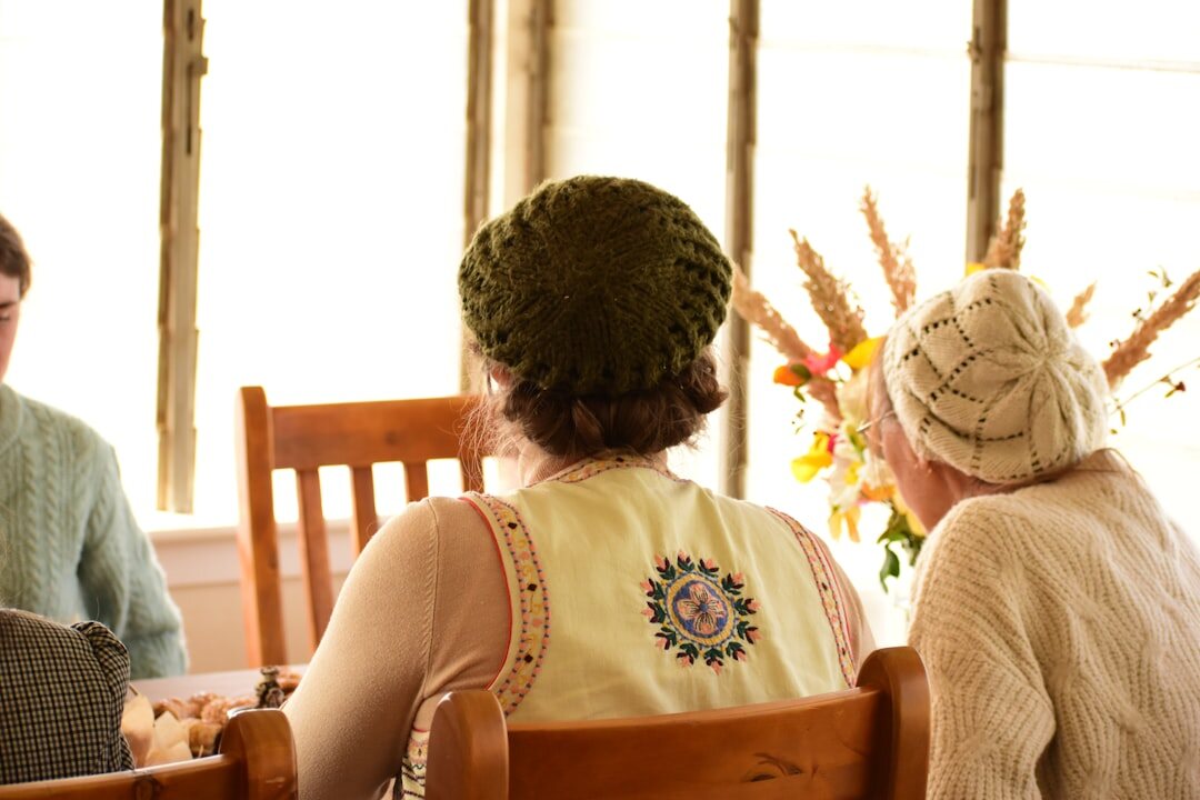 Seniors sitting together at table playing cards and enjoying conversation