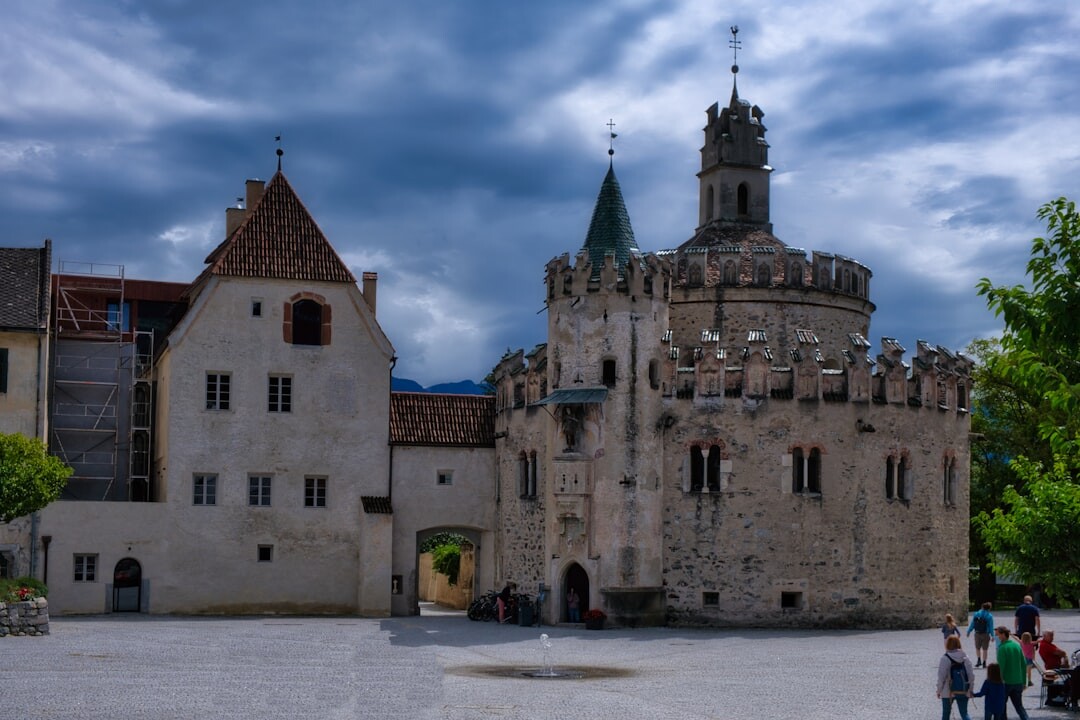Group of seniors on a sightseeing trip in front of a historic castle