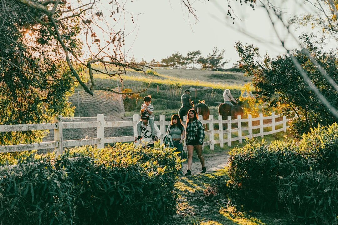 Group of smiling senior friends walking together outdoors in a park